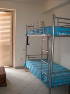 A bed or beds in a room at Case Vacanza Alega Mare