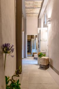 a hallway of a building with a door and flowers at Borgo San Gaetano in Bernalda