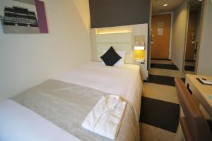 Postel nebo postele na pokoji v ubytování Hotel Sunroute Stellar Ueno