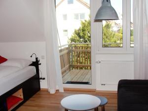 a bedroom with a bed and a door with a balcony at Haus Meersburg Garten in Meersburg