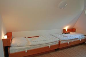 a bed in a room with two lights on it at Apartment 11 - Maisonette in Heiligenhafen