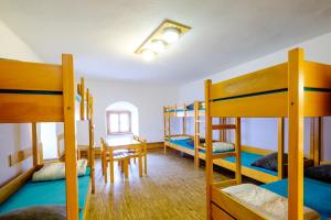 a room with four bunk beds and a table at Jugendherberge Saldenburg in Saldenburg