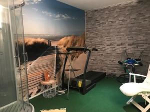 a room with a gym with a painting on the wall at Alain et Nicole in Cognac