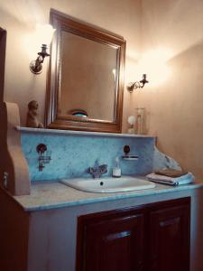 a bathroom with a sink and a mirror at La Gracette in Aix-en-Provence