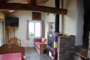 a living room with a fireplace and a couch at Le clos de Tournes in Echinghen