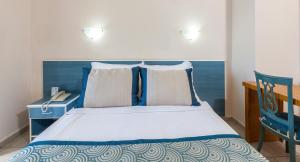 A bed or beds in a room at Galaxy Beach Hotel Alanya