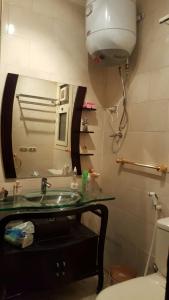 a bathroom with a sink and a mirror and a toilet at Chalet in Pyramids Porto Sokhna in Ain Sokhna