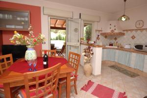 a kitchen and a dining room with a table and chairs at Villa Paladino in Castellammare del Golfo