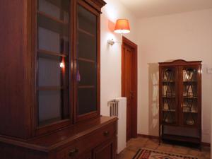 a room with a large wooden cabinet next to a hallway at Villa Di Papa' in Gaeta