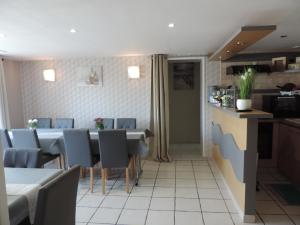 a kitchen and dining room with a table and chairs at Chambres d'Hotes La Maison Neuve in Saint-Loup