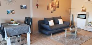 a living room with a couch and a table at Fewo Purper in Frauenberg