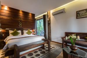 Giường trong phòng chung tại Khmer Paradise Villa