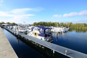 a group of boats docked at a dock in the water at Luxstay Werder in Kolonie Roeske
