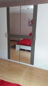 a mirror reflection of a bedroom with a bed in it at Emmerich`s Ferienwohnung in Frebershausen