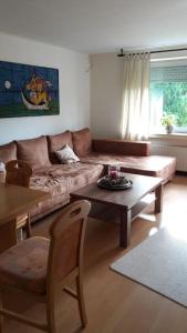 a living room with a couch and a coffee table at Emmerich`s Ferienwohnung in Frebershausen