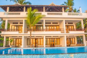 a villa with a swimming pool in front of it at 36 Palms Residency - Sea View Villa in Cochin
