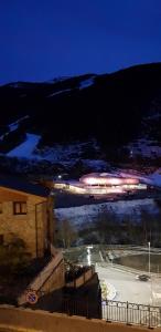 a train traveling down a track with snow on the ground at Soldeu Paradis Gran Sol in El Tarter