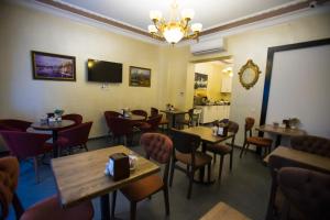 a restaurant with tables and chairs and a clock on the wall at The Void Hotel - Sisli Istanbul in Istanbul