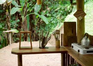 a wooden table with utensils on top of it at Amazonita Ecolodge in Dos Brazos