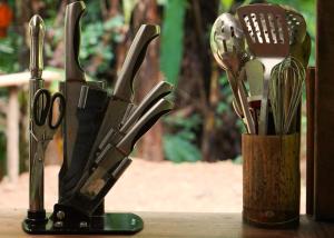 a group of knives in a container on a table at Amazonita Ecolodge in Dos Brazos