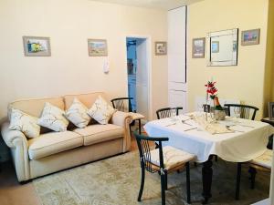 a living room with a couch and a table at Little Mermaid Cottage in Dawlish