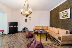 a living room with a couch and a table at Comfortable House on Marjanishvili in Tbilisi City
