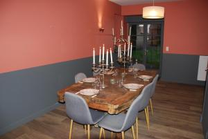 a dining room with a wooden table and chairs at La Bergerie - Gîte et Chambres d'Hôtes in Roz-sur-Couesnon