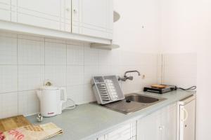 a kitchen counter with a sink and a toaster at Kontessa Apartments in Kefalos