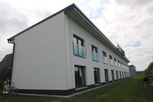 a white building with windows on the side of it at KF Hotel by WMM Hotels in Kaufbeuren