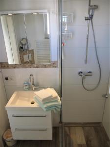 a bathroom with a shower and a sink at Strandperle 3 in Scharbeutz +19 photos