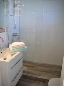 a bathroom with a white sink and a shower at Strandperle 3 in Scharbeutz