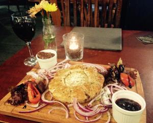 a wooden table with a plate of food on a table at Red Lion Coaching Inn in Ellesmere