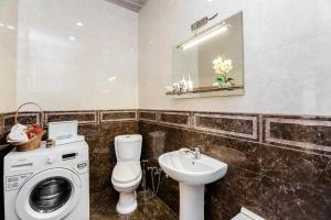 a bathroom with a washing machine and a sink at Comfortable House on Marjanishvili in Tbilisi City +38 photos
