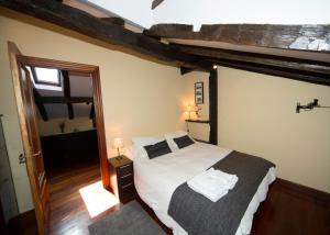 a bedroom with a large bed in a room at Saioa`s red house in Lekeitio