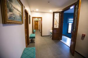 a hallway with blue walls and a hallway with green seats at The Void Hotel - Sisli Istanbul in Istanbul