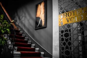 a staircase with a red carpet and a picture of an elephant at The Void Hotel - Sisli Istanbul in Istanbul +36 photos