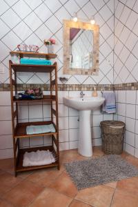 a bathroom with a sink and a mirror at La Croix du Sud 1 in Cilaos