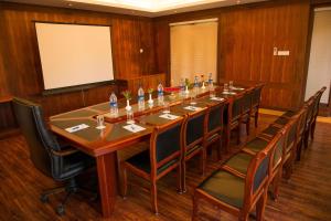 a large conference room with a long table and chairs at Esthell Village Resort in Mahabalipuram