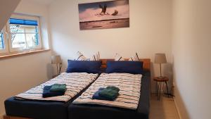 a bedroom with a bed with two pillows on it at Ferienwohnung Kranichblick in Zingst