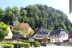 a group of buildings in front of a mountain at Ferienwohnung Detlef Pascher in Kurort Oybin