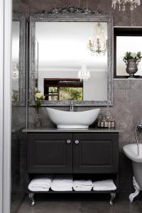 a bathroom with a sink and a mirror at Villa Petit in Jeffreys Bay