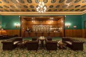 a large room with couches and a bar at Legendary Hotel Sovietsky in Moscow