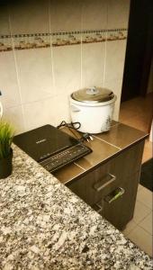 a kitchen with a counter top with a slow cooker at SHA GATHERING ALOR GAJAH BUNGALOW, A FAMOSA MELAKA in Melaka
