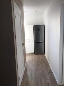 an empty hallway with a refrigerator in a room at My Kingdom in Gulbene