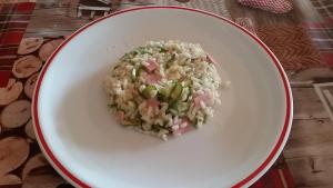 a white bowl filled with rice and peas at Garnì Fobbie in Brentonico