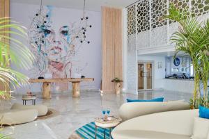 a living room with couches and a painting on the wall at Steigenberger Pure Lifestyle (Adults Only) in Hurghada