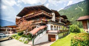 a large house with flowers on the balconies of it at Appartement Winkler in Waidring