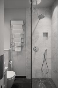 a bathroom with a shower and a toilet at Penally Abbey Country House Hotel and Restaurant in Tenby