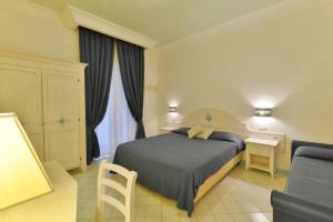 Postel nebo postele na pokoji v ubytování La Pineta Hotel Beach & Spa