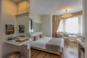 Postel nebo postele na pokoji v ubytování Hotel Yasmak Sultan